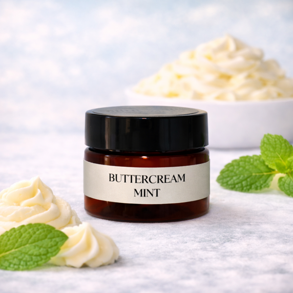 Jar of Buttercream Mint lip butter with whipped cream and mint leaves on a light background