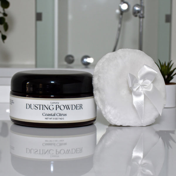 Dusting powder jar with a white powder puff on a bathroom counter