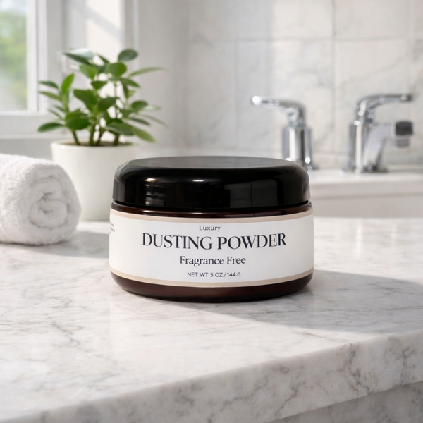 Jar of dusting powder on a marble countertop with a plant and sink in the background