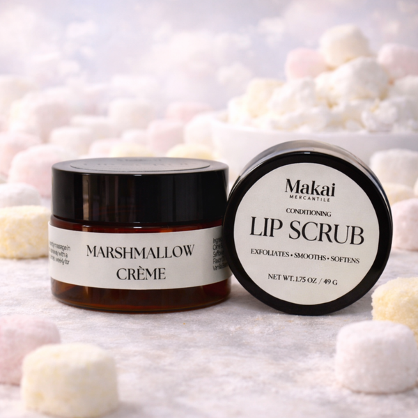 Two lip care products, 'Marshmallow Crème' and 'Lip Scrub', on a soft, blurred background with marshmallows.