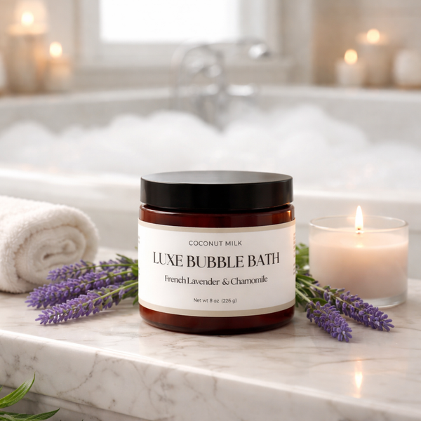 Jar of luxe bubble bath with lavender and a candle on a bathroom counter