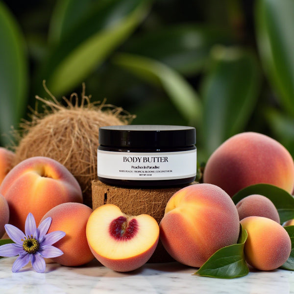 Body butter jar with peaches and a coconut on a green leafy background in Peaches in Paradise scent