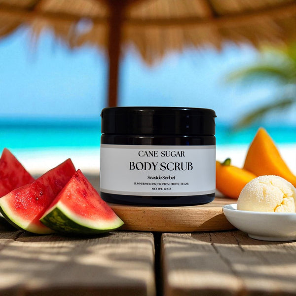 Premium cane sugar exfoliating body scrub in Seaside Sorbet  fragrance on a wooden table with a stray umbrella on the beach