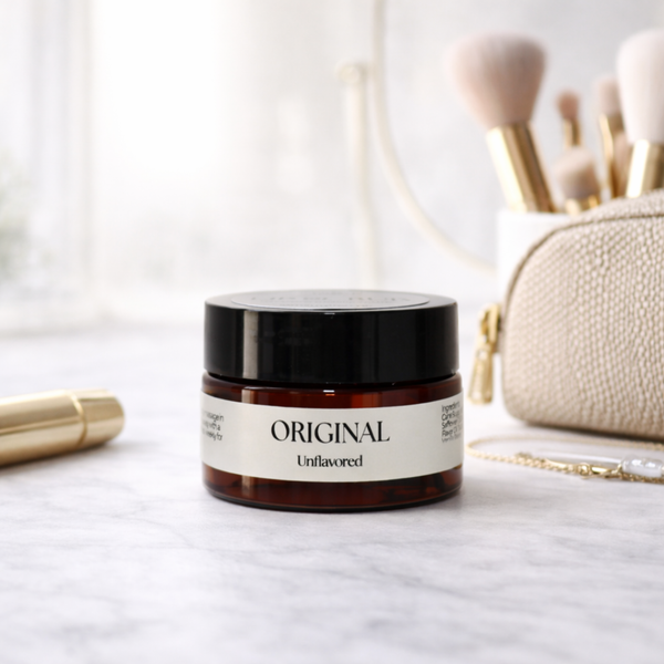 Skincare jar labeled 'Original Unflavored' with makeup brushes and a pouch in the background. Unflavored Lip Scrub.