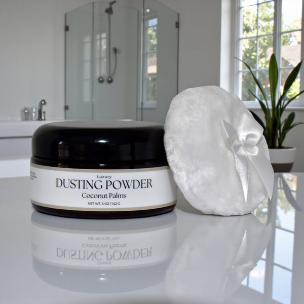 Jar of 'Luxury Dusting Powder' with a puff on a bathroom counter.