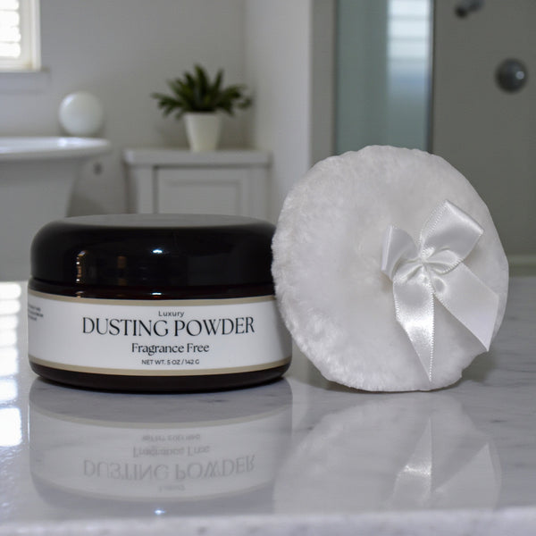 Dusting powder jar with a white puff on a bathroom counter