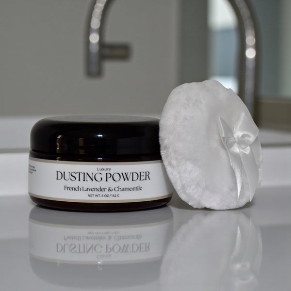 Dusting powder jar with a puff on a bathroom counter