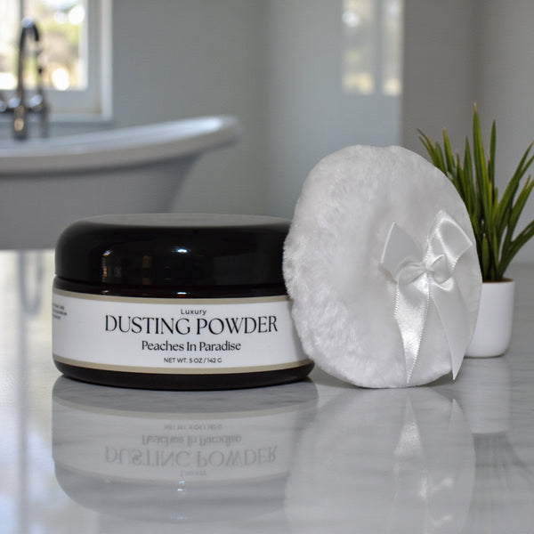 Dusting powder jar with a puff on a bathroom counter